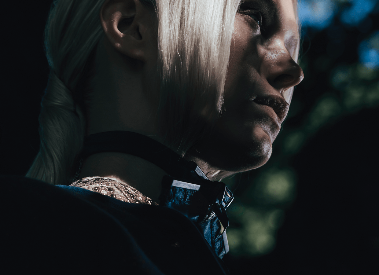 Girl with Harpyia collar with bird face and strong shadow